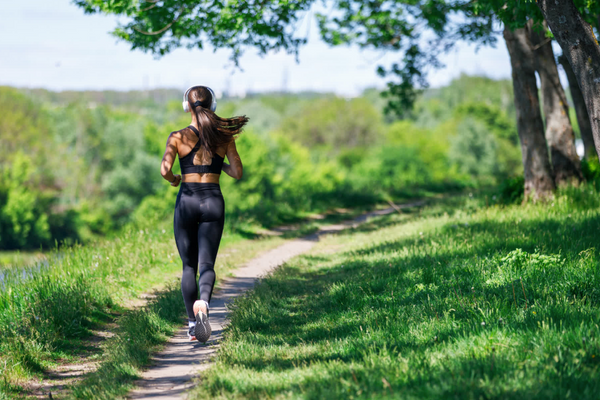 woman jogging alone on an empty pathway